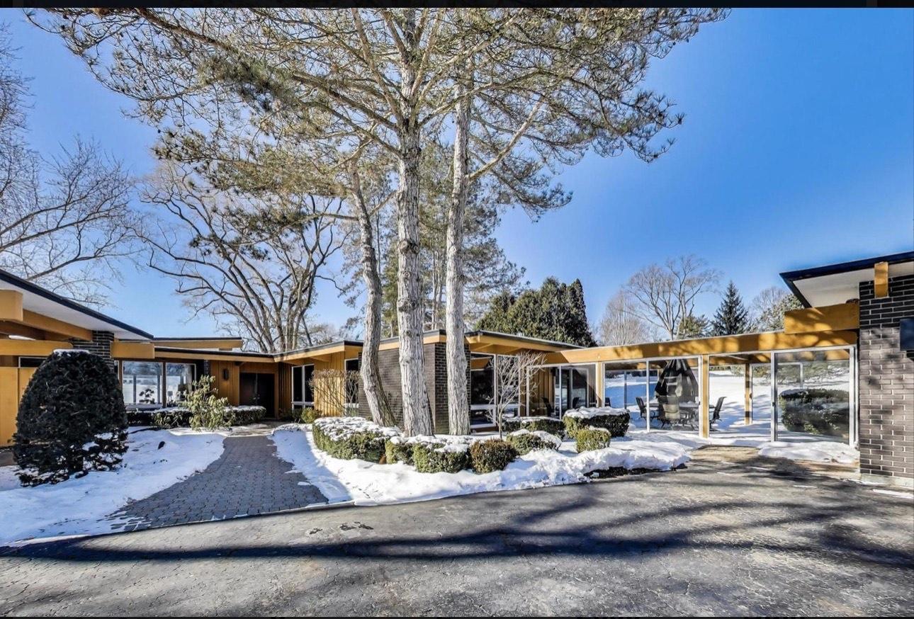 A mid-century modern home on a wooded lot